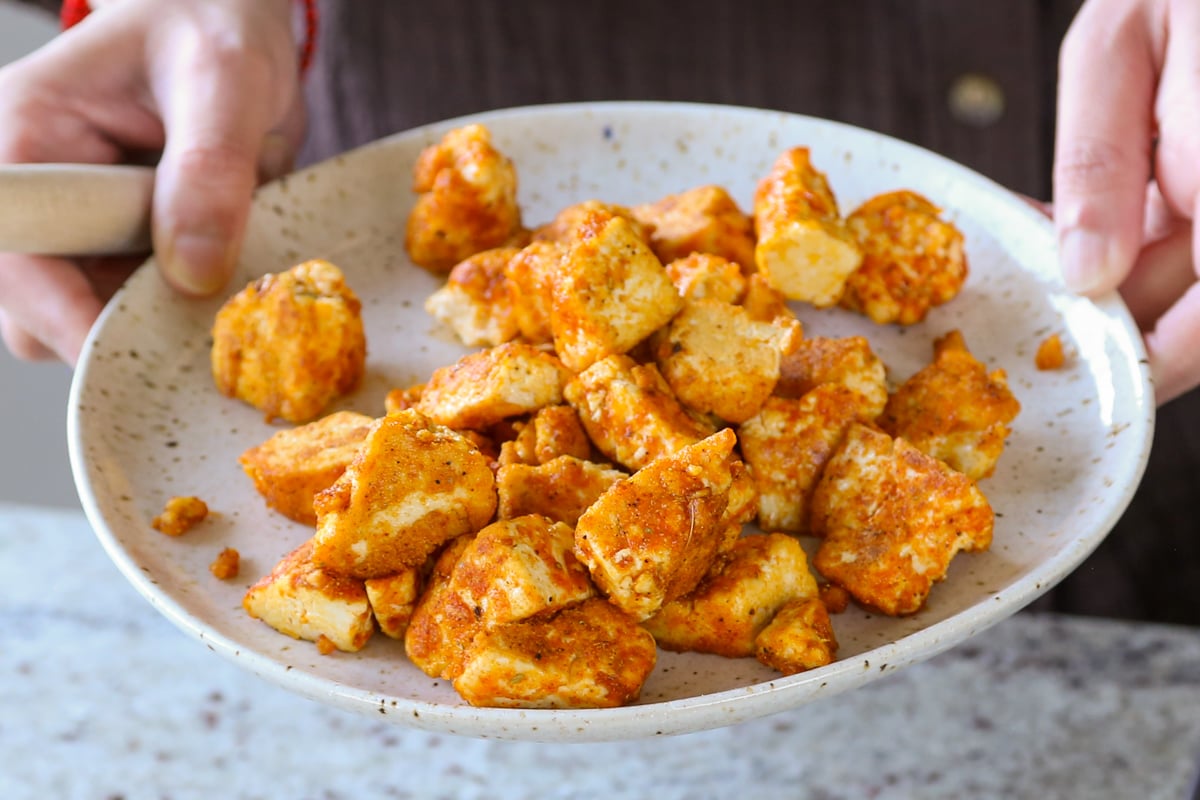 setting cooked tofu aside on a plate