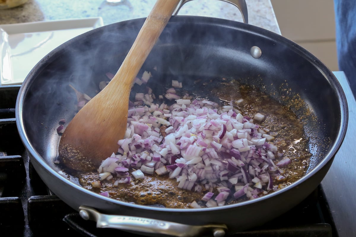 adding the onion to the pan