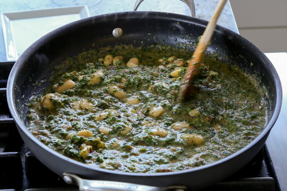 saag butter beans in the pan before cooking down