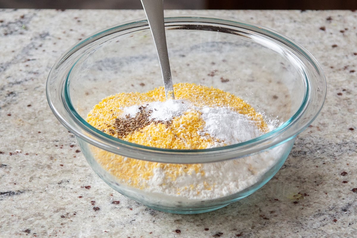 cornmeal, flour and spices in a glass bowl 