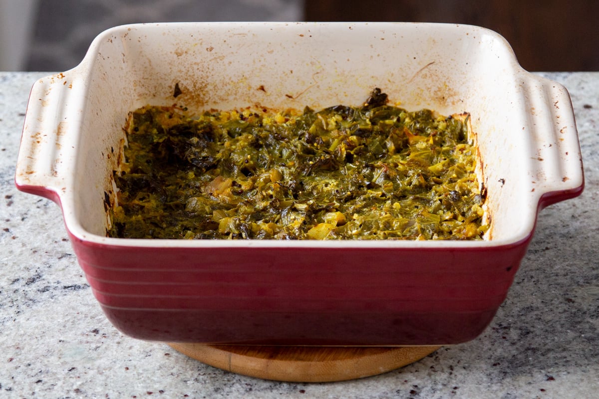 mustard greens in a red casserole dish 