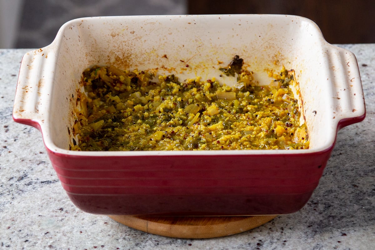 baked Indian saag stew in a red casserole dish 