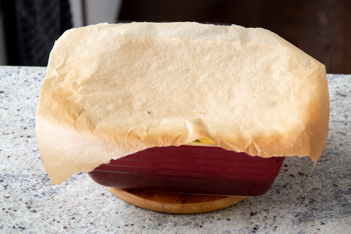 a casserole dish dopped with a piece of parchment paper