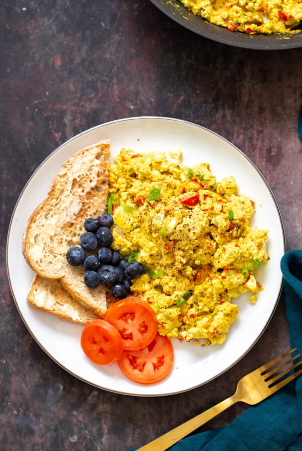 vegan tofu scramble served with a side of toast and vegetables