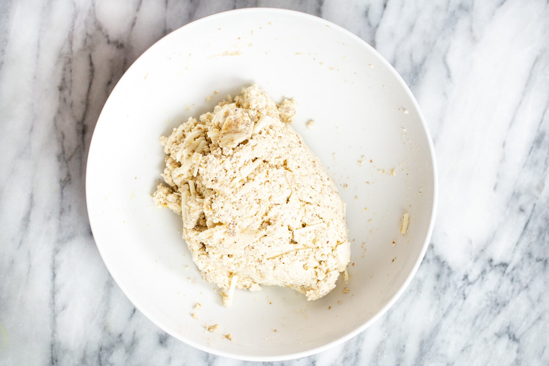 vegan tofu in a white bowl on a marble countertop 