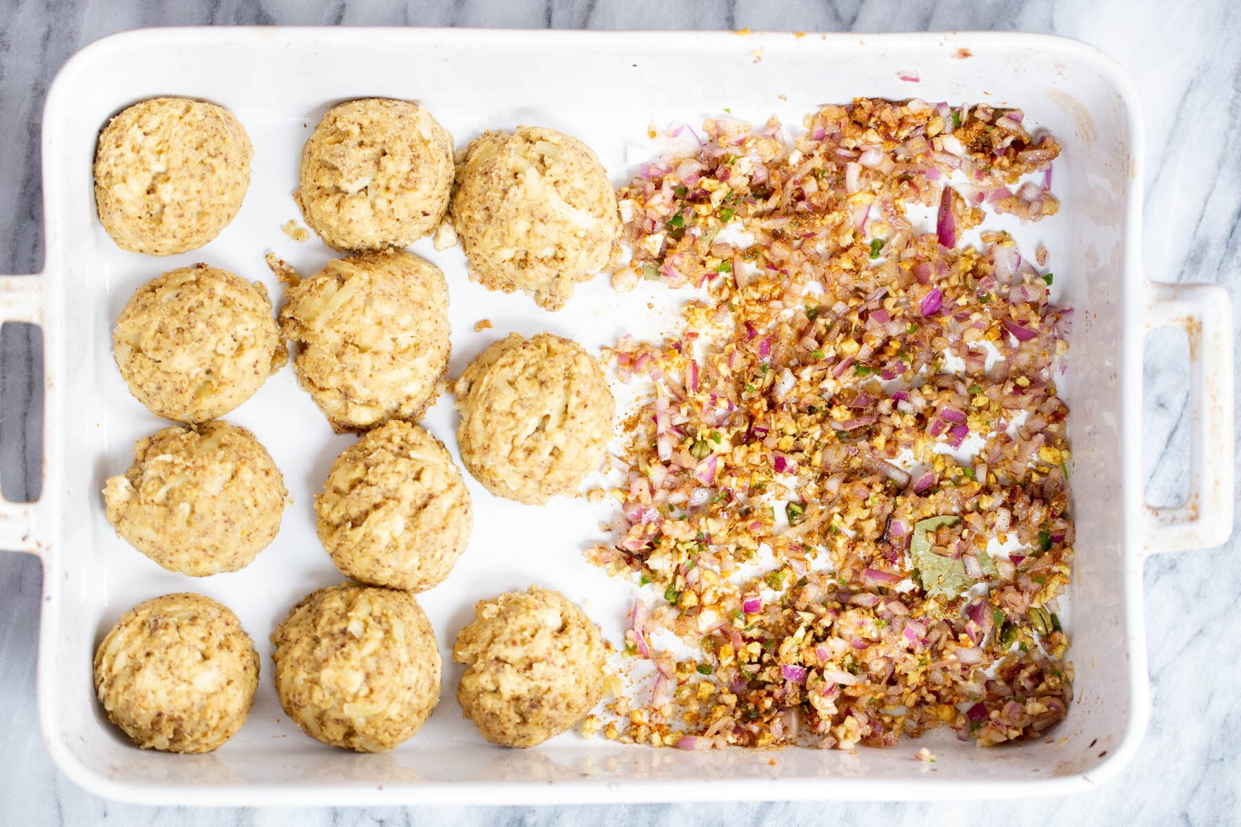 vegan tofu kofta next to minced onions, chili and ginger