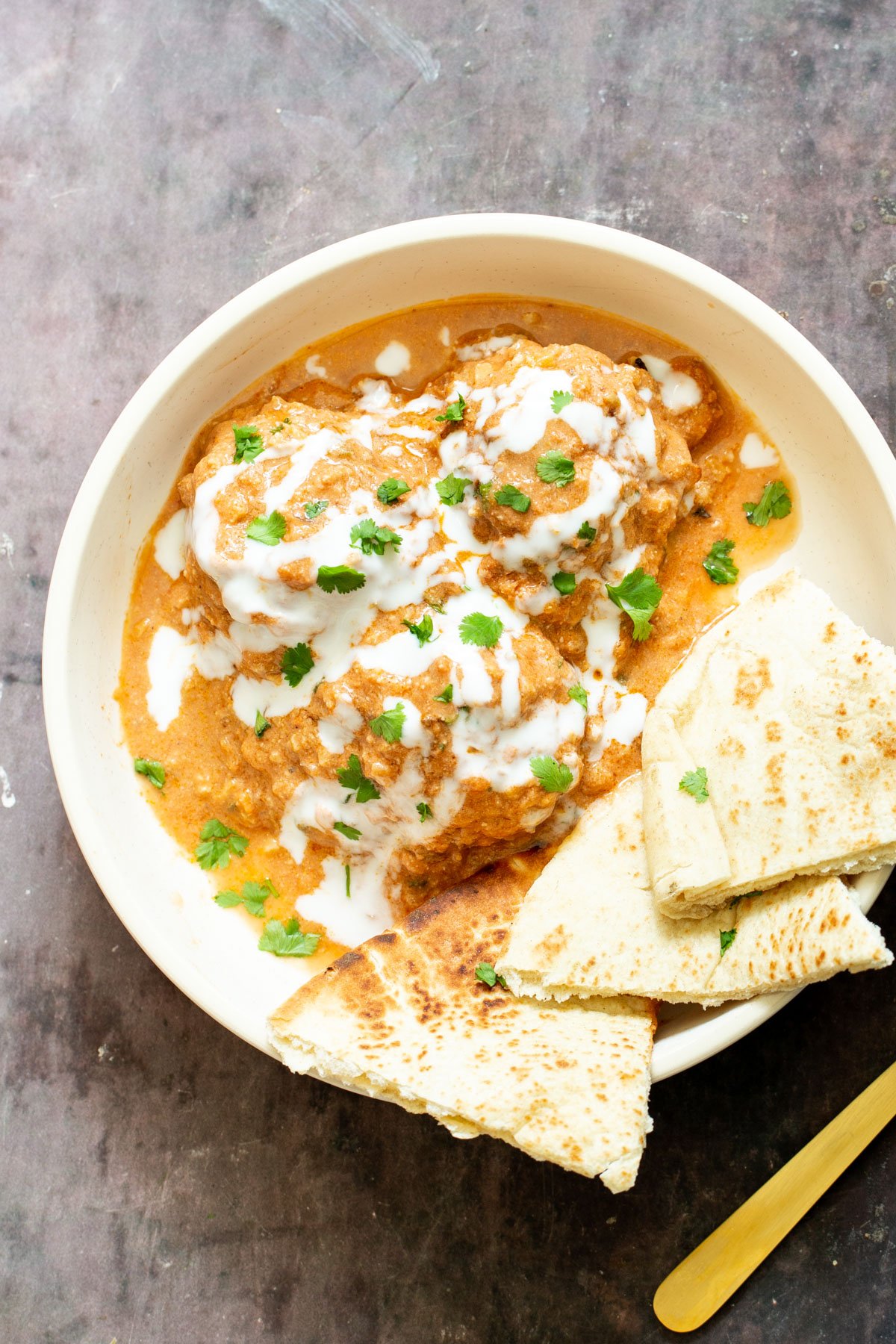 vegan shahi tofu kofta in a white bowl with vegan naan 