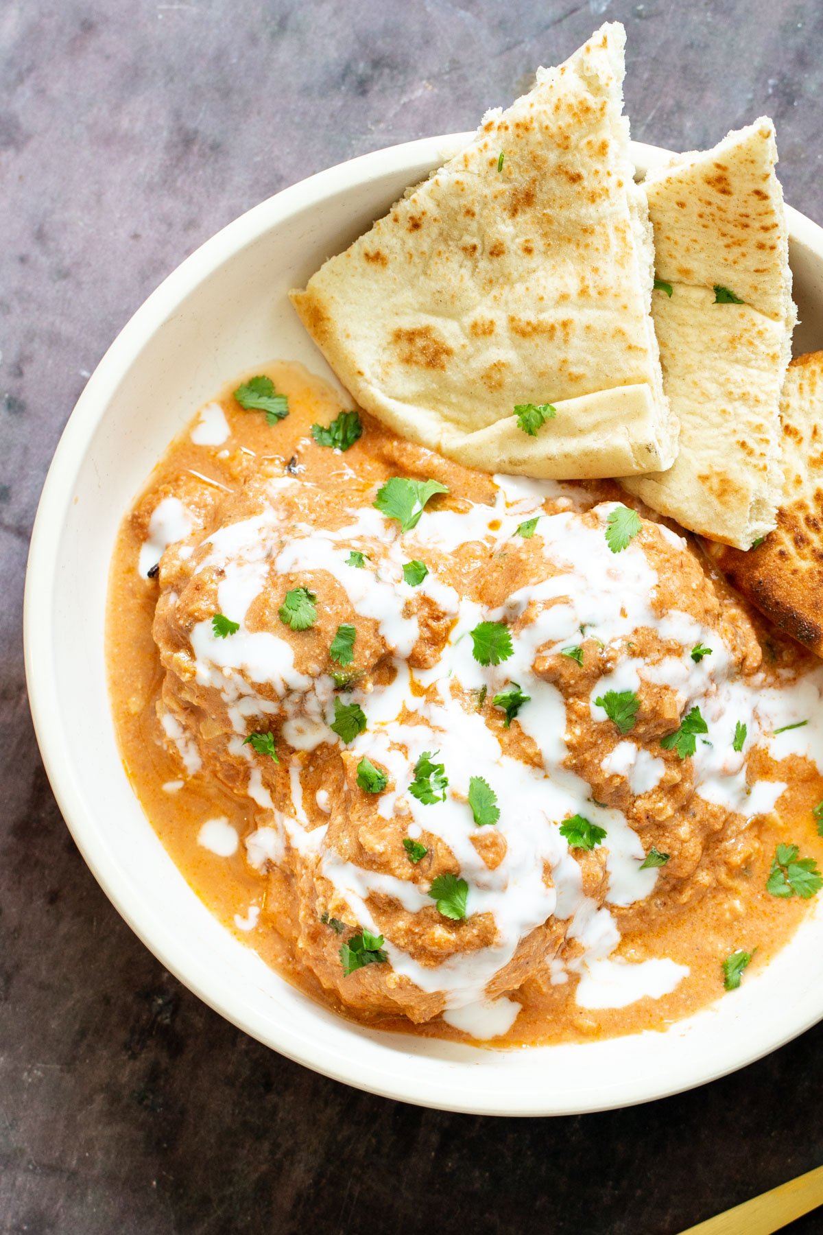 tofu kofta in creamy tomato sauce served with Indian flatbread 