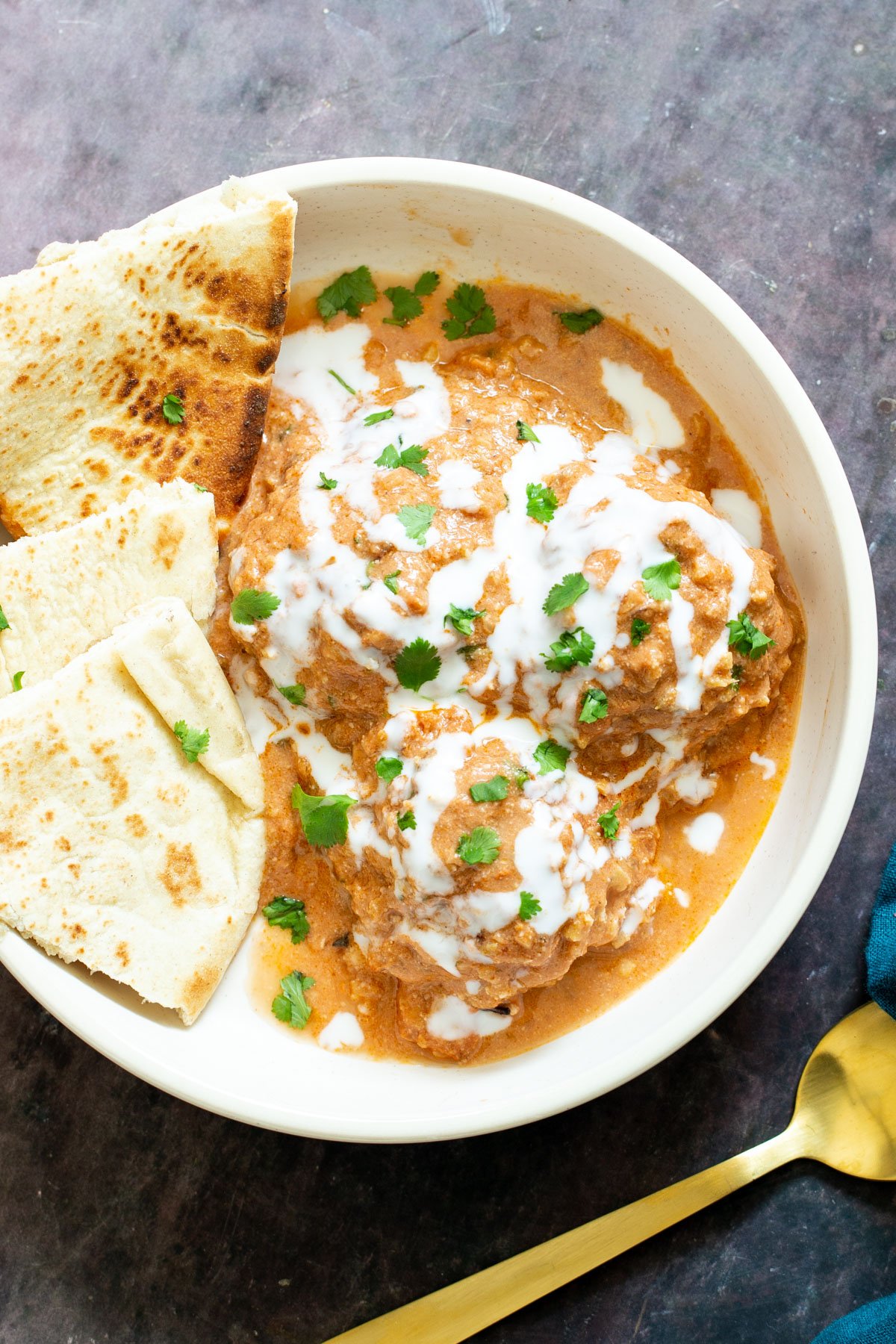 shahi tofu kofta casserole served in a bowl with naan bread on the side