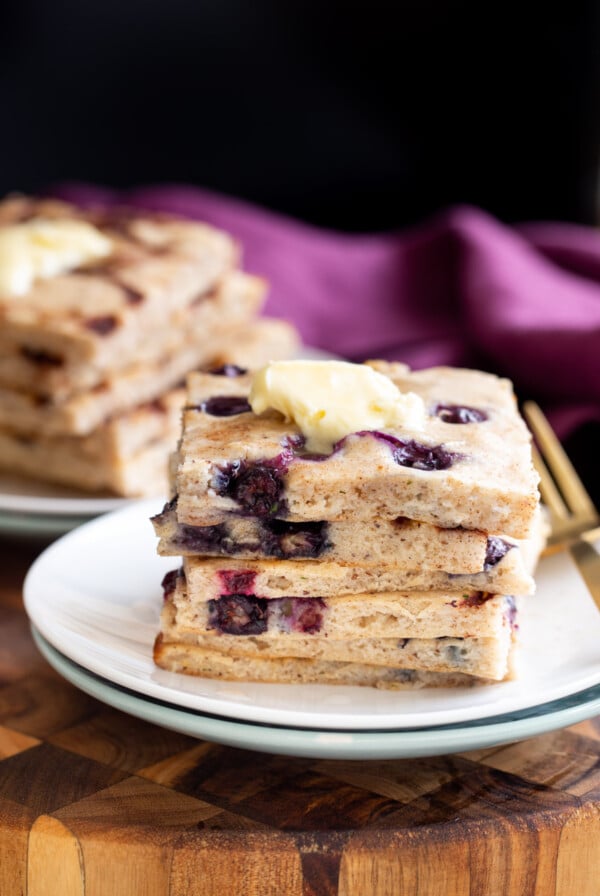 vegan sheet pan pancakes stacked on a white plate