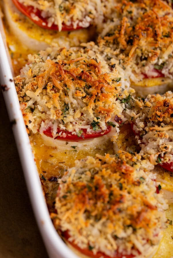 close-up of baked vegan caprese stacks in the baking dish, after baking