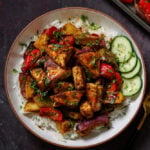 tofu tray bake in a bowl with rice and cucumber slices