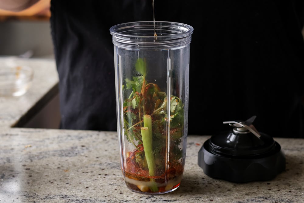 adding marinade ingredients to the blender