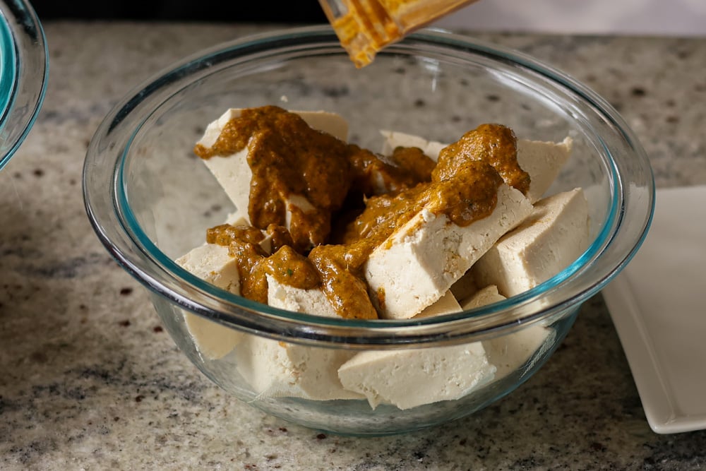 adding marinade to the tofu