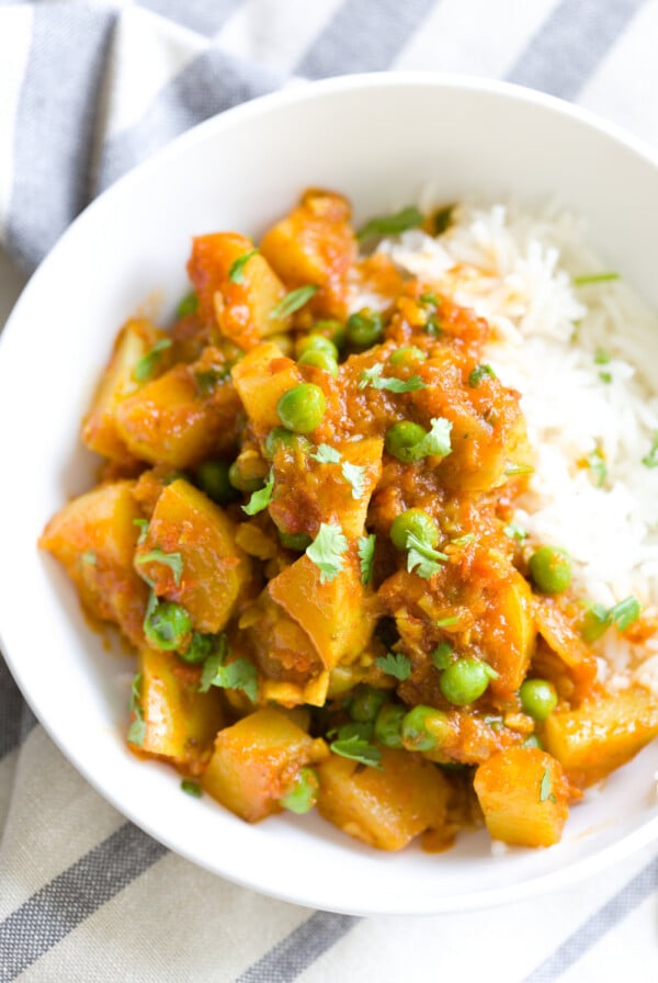 a serving of Indian Aloo Matar Pea and Potato Curry with a side of rice