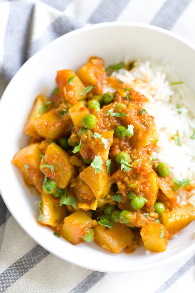 a serving of Indian Aloo Matar Pea and Potato Curry with a side of rice