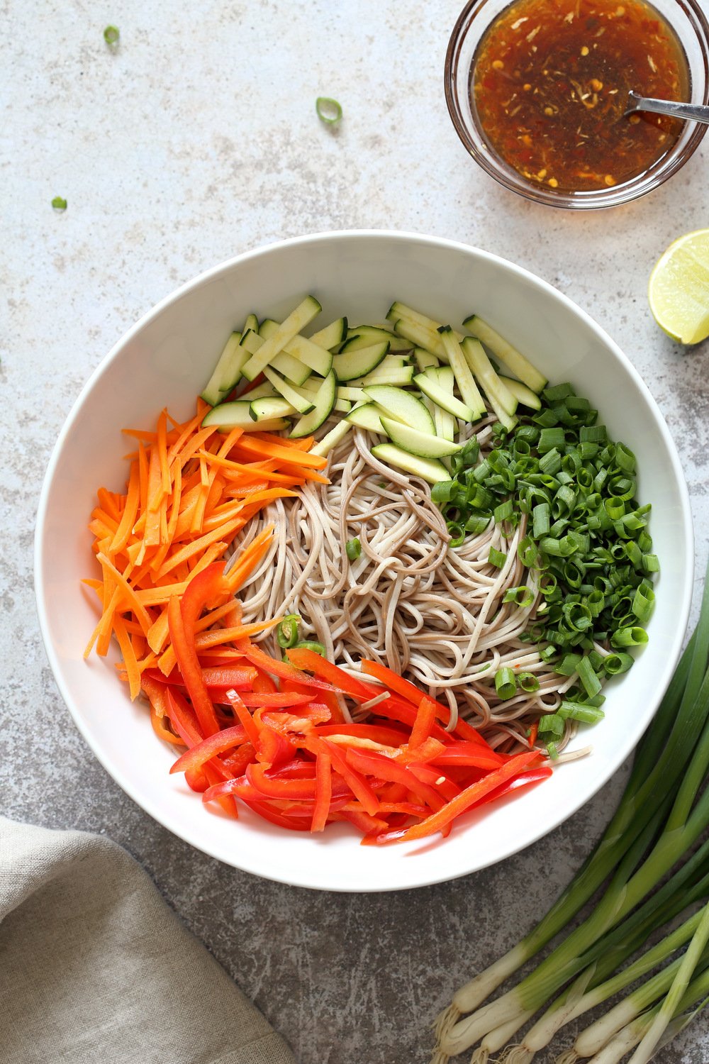 Our Cold Soba Noodle Salad Bowl Ingredients ready to be tossed in Sesame ginger Dressing