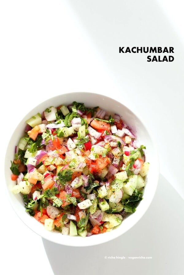 Kachumber Salad - Cucumber Tomato Onion Salad Recipe. Kachumbar is a simple chopped Summer Salad with chopped onions, tomatoes, cucumbers and a salt pepper lemon dressing. Serve as a side with Indian curries, or as a dip with chips, or over burgers. Vegan Gluten-free Soy-free Oil-free Recipe | VeganRicha.com #vegan #glutenfree #veganricha