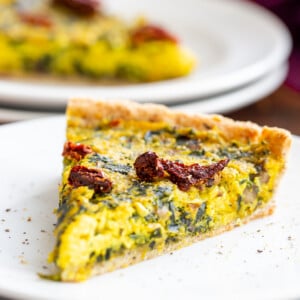 a slice of vegan quiche with spinach and leeks