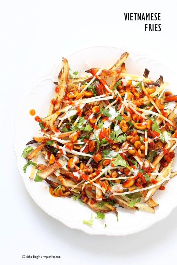 Baked Vietnamese fries. Baked Potato strips, loads of cilantro and basil, bean sprouts, nuts in sweet chile sauce, sriracha and vegan mayo! Banh mi Sandwich in fries form. Vegan Gluten-free Recipe. | VeganRicha.com #vegan #glutenfree #veganricha