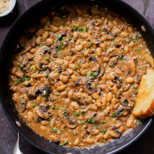 white bean stroganoff in the pan with toast