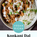 bowl of baked Konkani curry topped with coconut cream, cilantro, and pepper flakes, text overlay